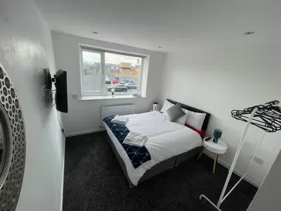 a small bedroom with a bed and a window at NEW PCK Thas Hotel BLACKPOOL in Blackpool