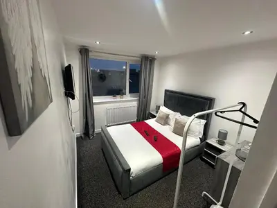a hotel room with a bed and a window at NEW PCK Thas Hotel BLACKPOOL in Blackpool