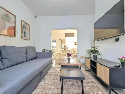 a living room with a couch and a table at Large 2-Bed Near City Centre & Anfield Parking in Liverpool