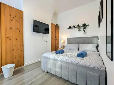 a bedroom with a bed with blue pillows on it at Large 2-Bed Near City Centre & Anfield Parking in Liverpool