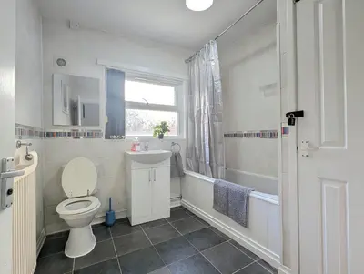 a bathroom with a toilet and a sink and a shower at Large 2-Bed Near City Centre & Anfield Parking in Liverpool