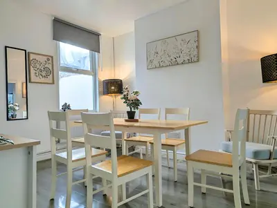 a dining room with a table and chairs at Large 2-Bed Near City Centre & Anfield Parking in Liverpool