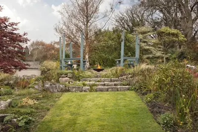 a garden with a fire pit in the middle at The Lookout - Ridgestone in Grange Over Sands