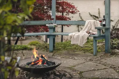 a fire pit in front of a bench with a fire pit at The Lookout - Ridgestone in Grange Over Sands