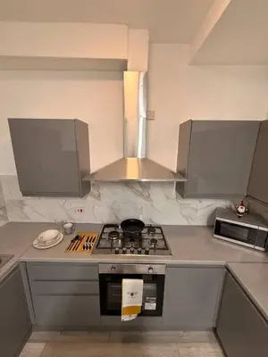 a kitchen with a stove and a microwave at Stylish Dream Home with 4 en-suite Bedrooms in Liverpool