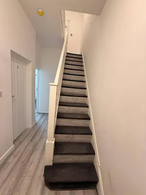 a staircase in a room with a stair case at Stylish Dream Home with 4 en-suite Bedrooms in Liverpool