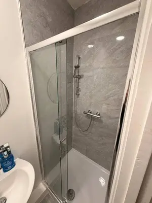 a shower with a glass door in a bathroom at Stylish Dream Home with 4 en-suite Bedrooms in Liverpool