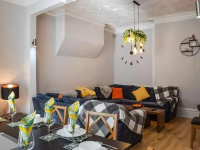 a living room with a couch and a table at Contractor's Rest in Blackpool