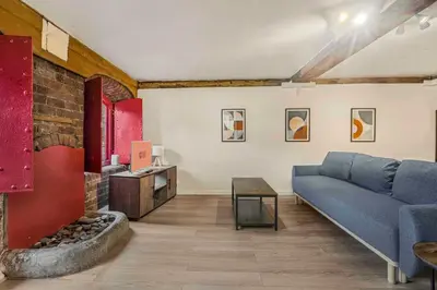 a living room with a couch and a fireplace at GuestReady - Cozy retreat in vibrant Liverpool in Liverpool