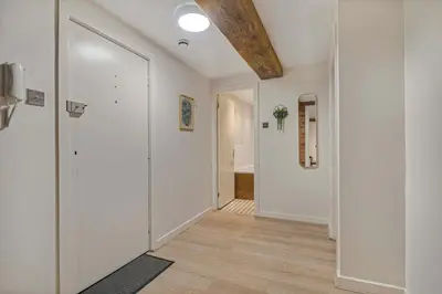 a hallway with white walls and a wooden floor at GuestReady - Cozy retreat in vibrant Liverpool in Liverpool