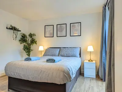 a bedroom with a bed with blue pillows on it at Guest Rooms Near Centre & Anfield Free Parking in Liverpool
