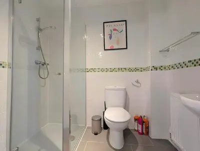 a bathroom with a toilet and a shower and a sink at Guest Rooms Near Centre & Anfield Free Parking in Liverpool