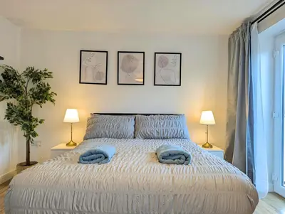 a bedroom with a bed with blue towels on it at Guest Rooms Near Centre & Anfield Free Parking in Liverpool