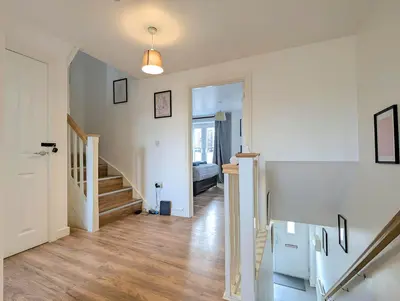 a hallway with stairs and a room with a bed at Guest Rooms Near Centre & Anfield Free Parking in Liverpool