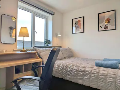 a bedroom with a desk and a bed and a desk chair at Guest Rooms Near Centre & Anfield Free Parking in Liverpool