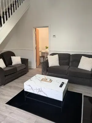 a living room with a couch and a coffee table at Deepdale House - Comfortable 2 Bedroom Home near Major Attractions in Preston in Preston