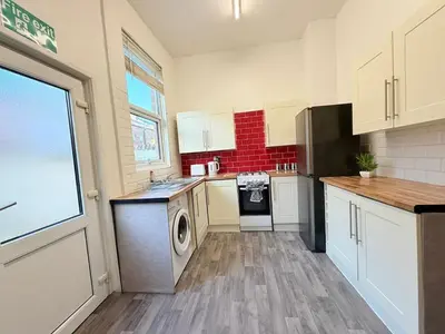 a kitchen with a washer and dryer in it at Deepdale House - Comfortable 2 Bedroom Home near Major Attractions in Preston in Preston