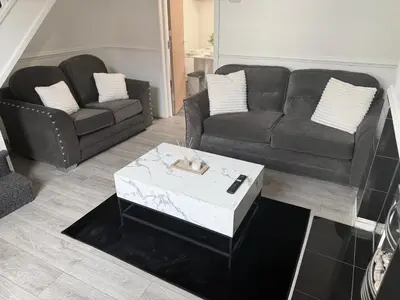a living room with two couches and a coffee table at Deepdale House - Comfortable 2 Bedroom Home near Major Attractions in Preston in Preston