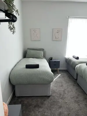 a room with a bed and a couch and a window at Spacious Home From Home, Parking, Contractors in Liverpool
