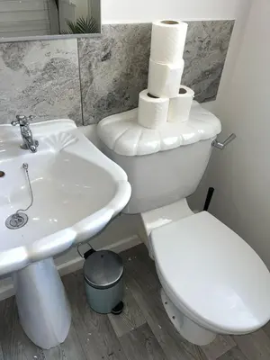 a bathroom with a white toilet and a sink at Spacious Home From Home, Parking, Contractors in Liverpool
