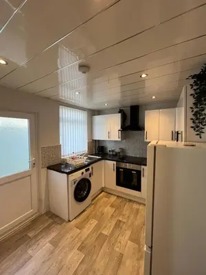 a kitchen with a white refrigerator and a washer at Spacious Home From Home, Parking, Contractors in Liverpool