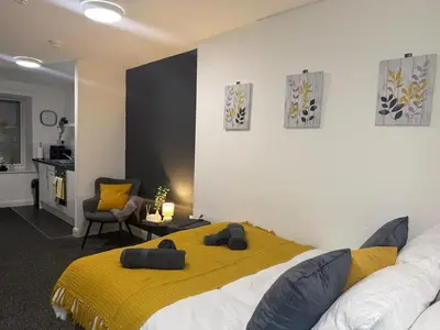 a bedroom with a bed with a yellow blanket at City-Close Studio By Escape & Estates Short Lets & Serviced Accommodation Liverpool with Free parking and Wifi in Liverpool