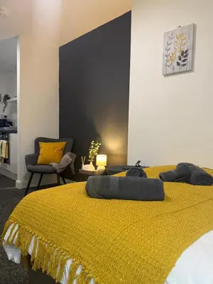 a bedroom with a yellow bed with two pillows on it at City-Close Studio By Escape & Estates Short Lets & Serviced Accommodation Liverpool with Free parking and Wifi in Liverpool