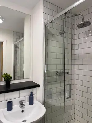 a bathroom with a sink and a glass shower at City-Close Studio By Escape & Estates Short Lets & Serviced Accommodation Liverpool with Free parking and Wifi in Liverpool