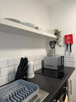 a kitchen with a counter top with a tray on the stove at City-Close Studio By Escape & Estates Short Lets & Serviced Accommodation Liverpool with Free parking and Wifi in Liverpool