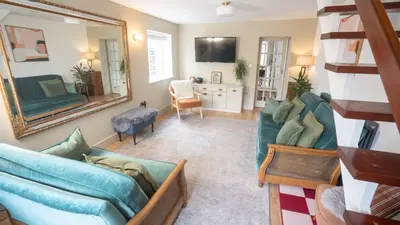 a living room with a couch and a mirror at Welcoming 3 bed home in Formby
