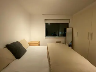 a bedroom with a large white bed with a window at Entire Pent House In Down Town Liverpool in Liverpool