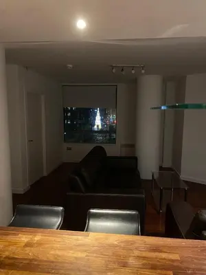 a living room with a couch and a table at Entire Pent House In Down Town Liverpool in Liverpool