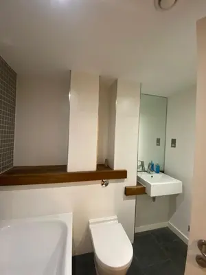 a bathroom with a toilet and a sink at Entire Pent House In Down Town Liverpool in Liverpool