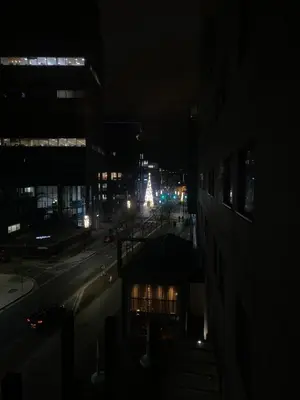 a city at night with a christmas tree in the distance at Entire Pent House In Down Town Liverpool in Liverpool