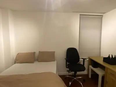 a bedroom with a bed and a desk and a chair at Entire Pent House In Down Town Liverpool in Liverpool