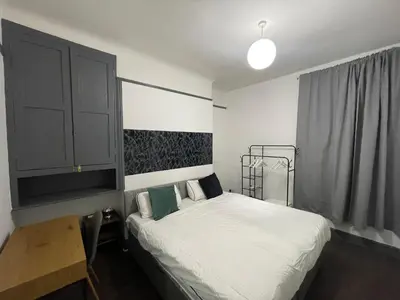a small bedroom with a bed and a cabinet at Liverpool 4-Bed Home, Free Parking in Liverpool