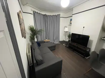 a living room with a couch and a flat screen tv at Liverpool 4-Bed Home, Free Parking in Liverpool