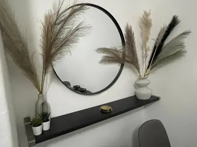 a black shelf with a mirror and some plants at Liverpool 4-Bed Home, Free Parking in Liverpool