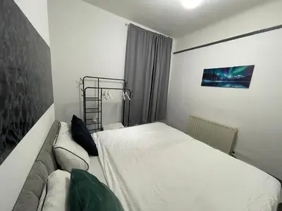 a small bedroom with a bed and a couch at Liverpool 4-Bed Home, Free Parking in Liverpool