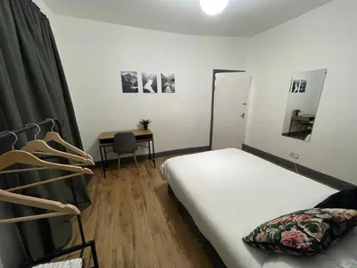 a small room with a bed and a desk at Liverpool 4-Bed Home, Free Parking in Liverpool