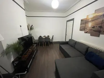 a living room with a couch and a table at Liverpool 4-Bed Home, Free Parking in Liverpool