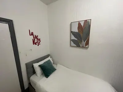 a bedroom with a bed and a picture on the wall at Liverpool 4-Bed Home, Free Parking in Liverpool