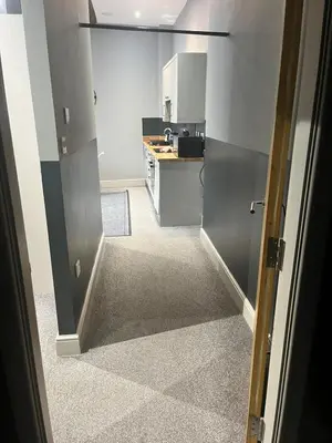 a kitchen with a door open to a kitchen with a counter at The Works Apartments in Liverpool