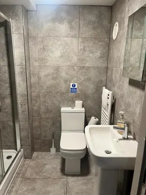 a bathroom with a white toilet and a sink at The Works Apartments in Liverpool