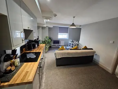 a small room with a bed and a kitchen at The Works Apartments in Liverpool