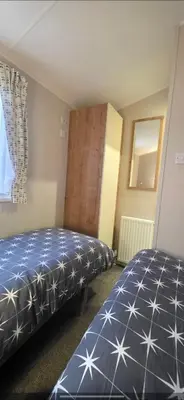 a bedroom with two beds and a window at Graham's Dream in Heysham