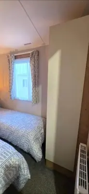 a bedroom with two beds and a window at Graham's Dream in Heysham