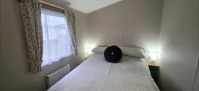 a bedroom with a bed with a hat on it at Graham's Dream in Heysham