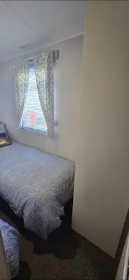 a bedroom with a bed and a window at Graham's Dream in Heysham