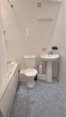 a bathroom with a toilet and a sink at Spacious 2BR, 5 Min Walk to Anfield, Free Parking in Liverpool